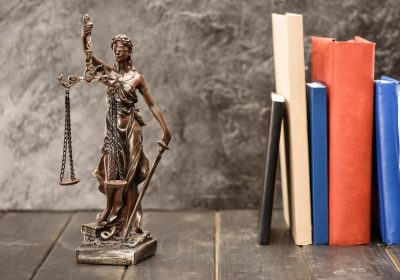 Close-up view of antique statue of lady justice and books, Law concept Close-up view of antique statue of lady justice and books, Law concept